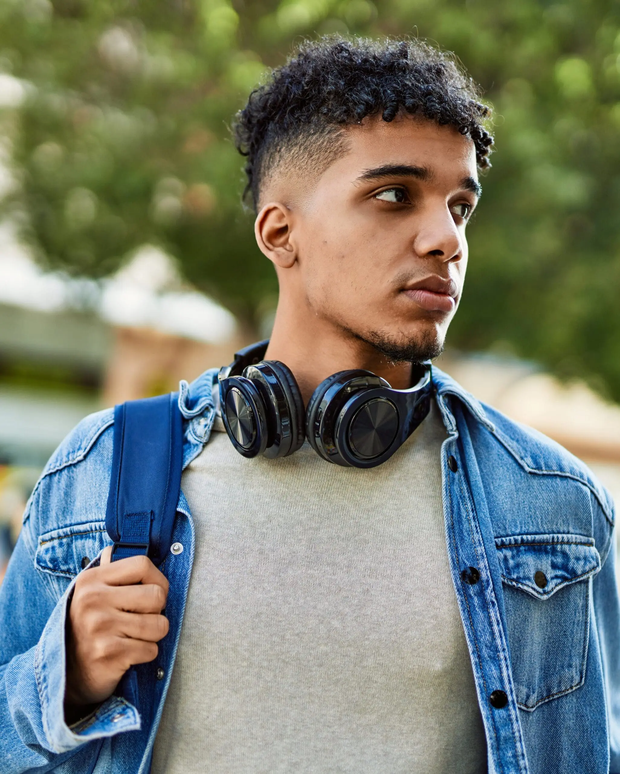 Hispanic young man looking serious and confident at the street