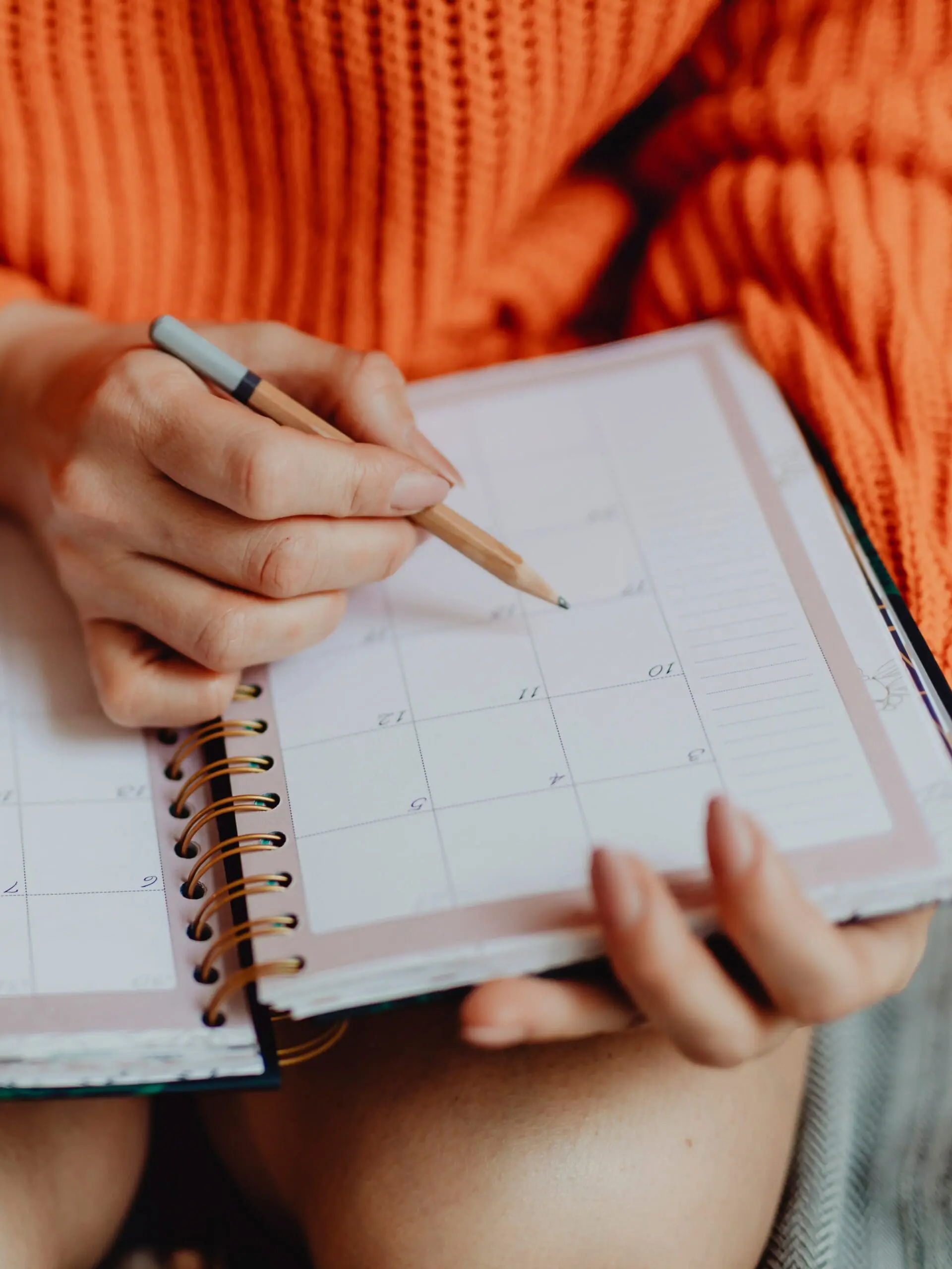 Woman writing on her daily planner