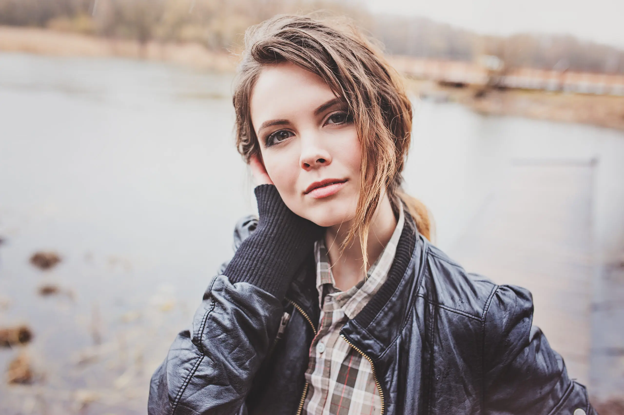outdoor portrait of young beautiful woman in leather jacket