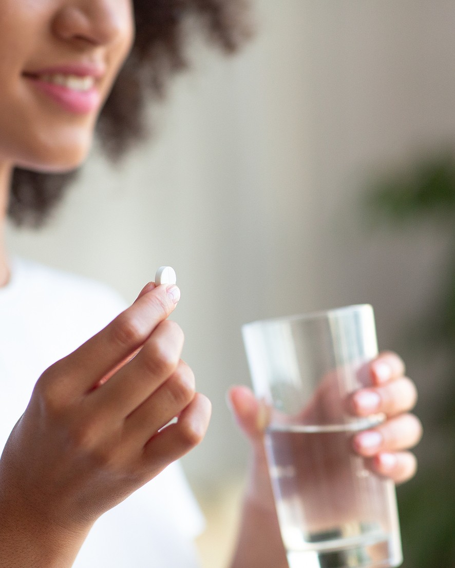 bigstock-Smiling-Woman-Taking-White-Rou-406969337